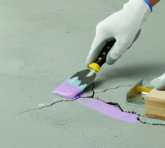 Applying SG Multi Gel Adhesive to a concrete crack